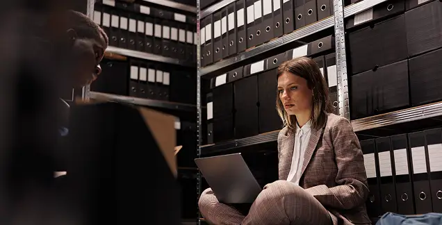Person reviewing organized archive files representing data separation