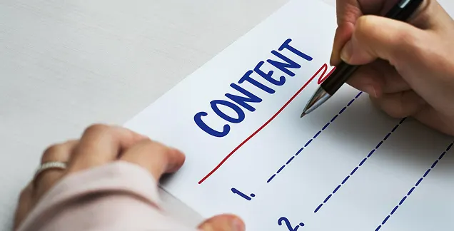 Hand writing on a content document representing content review notes