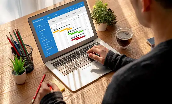 Employee tracking task activity on a laptop project dashboard