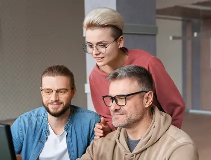 Software developers reviewing code together at a workstation